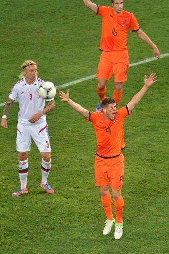 Dutch forward Klaas-Jan Huntelaar (R) gestures next to Danish defender Simon Kjær